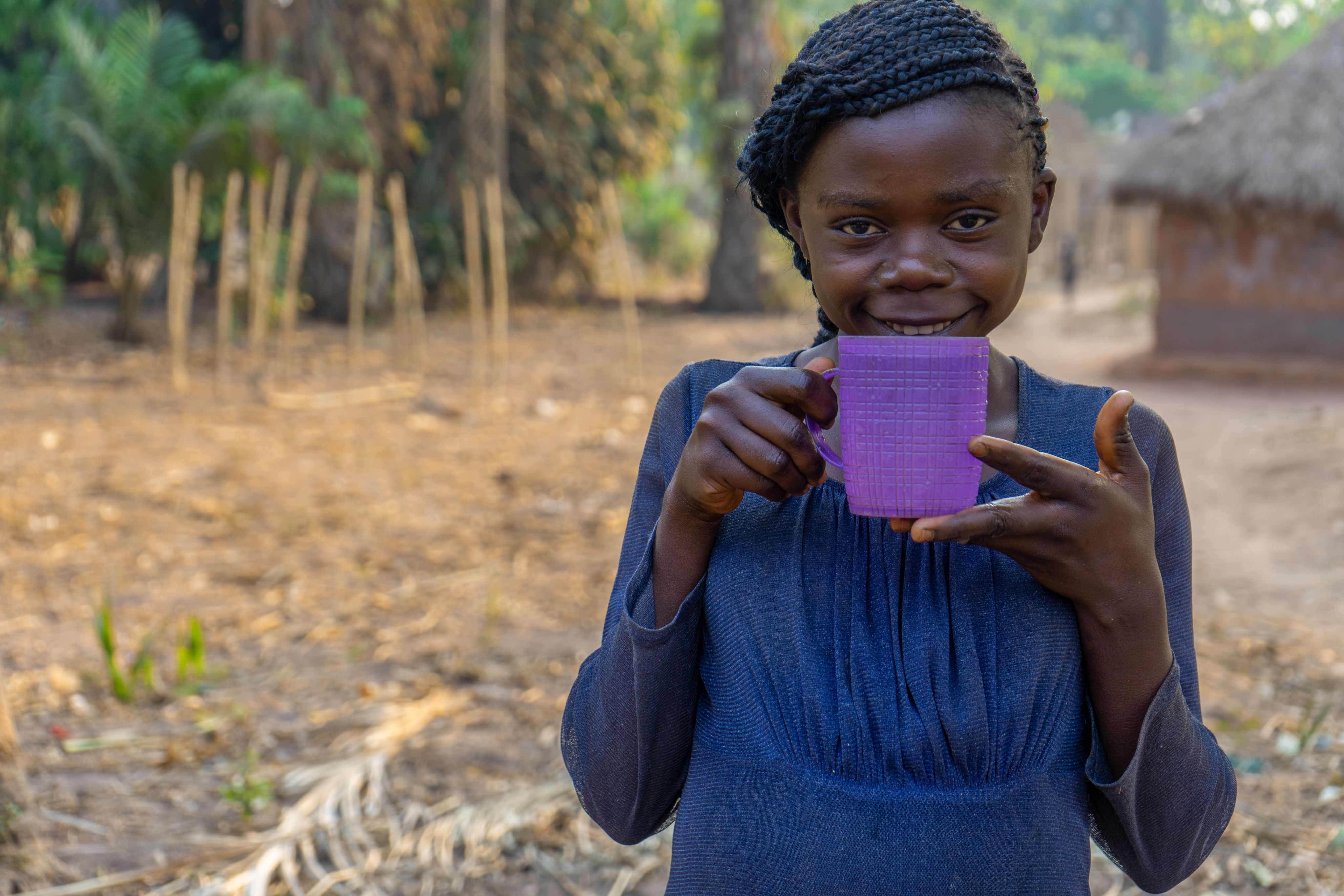 girl drinking water congo