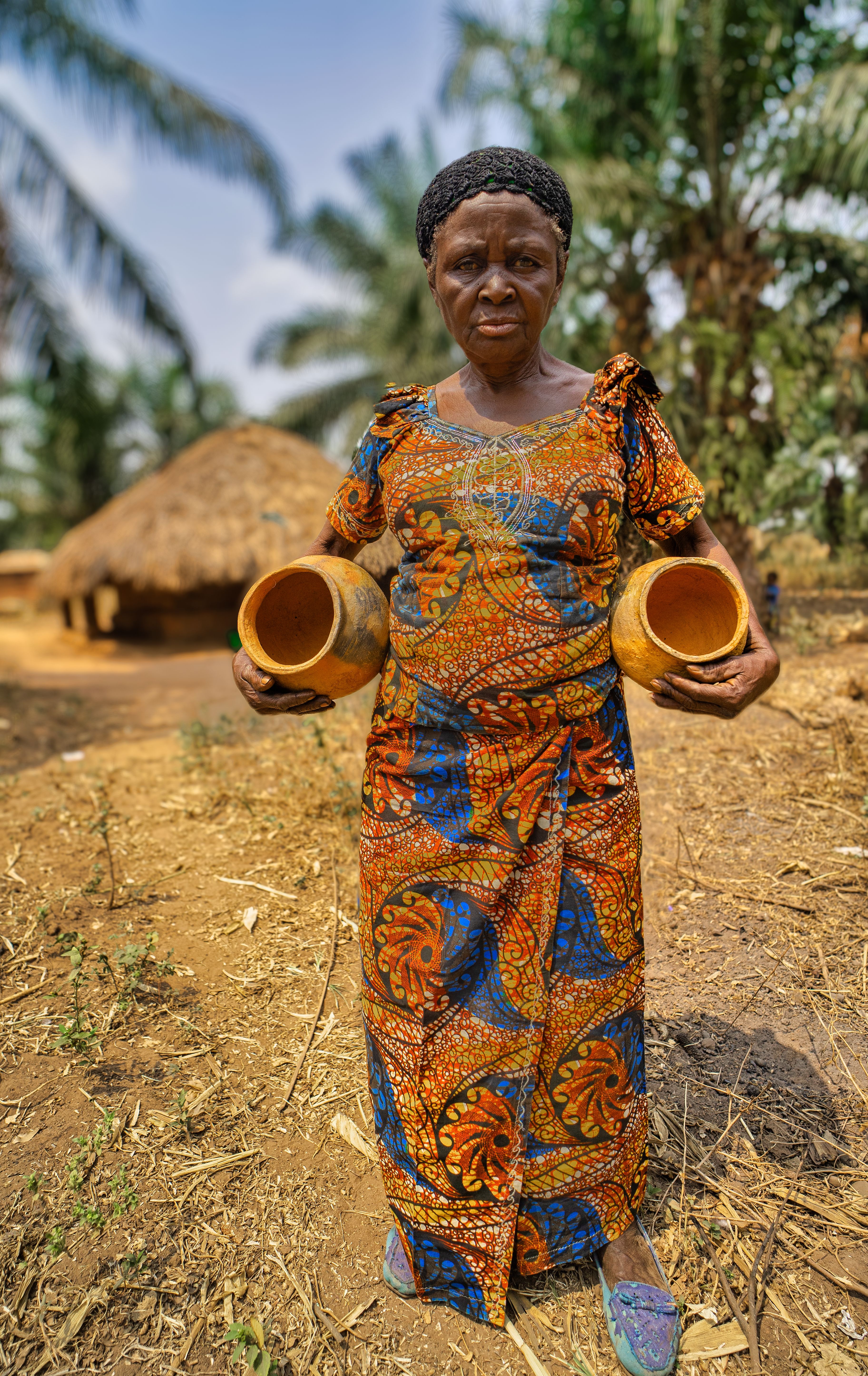 woman holding terracotta pots
