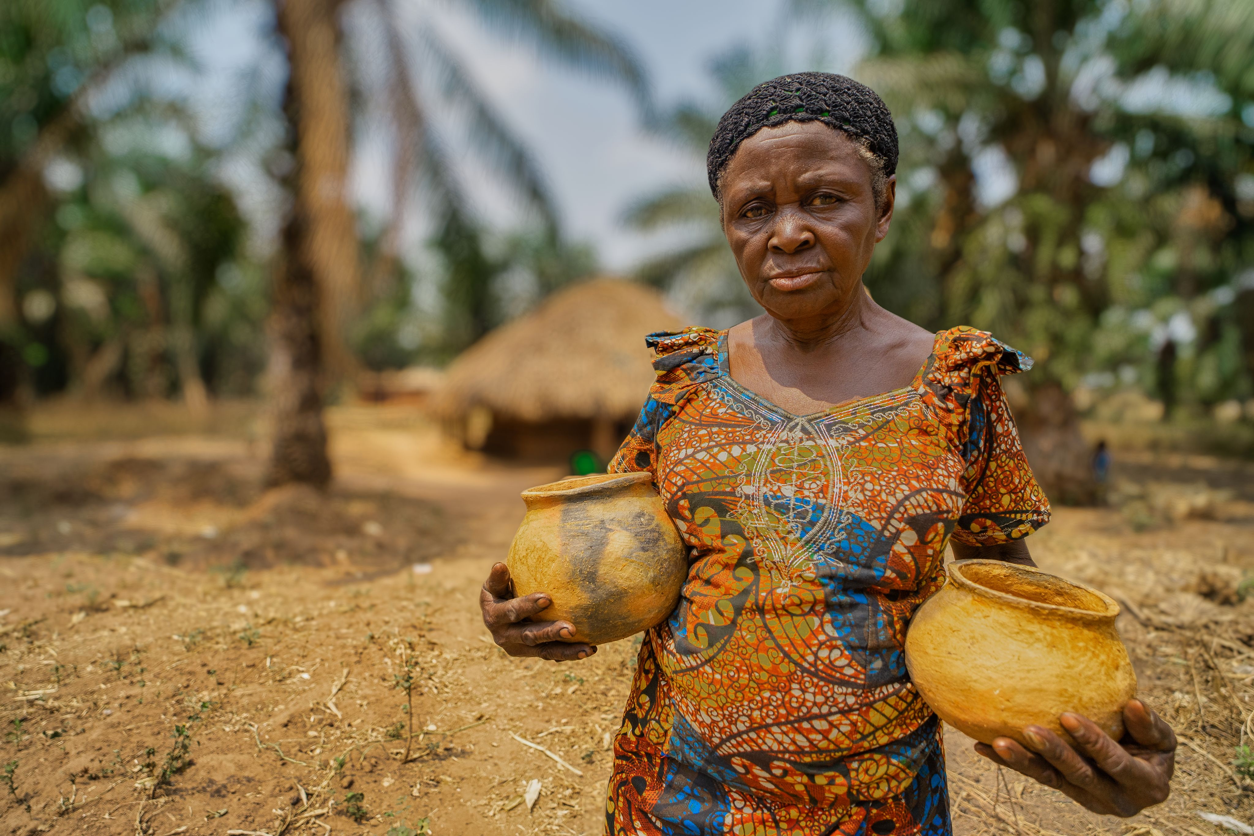woman holding terracotta pots